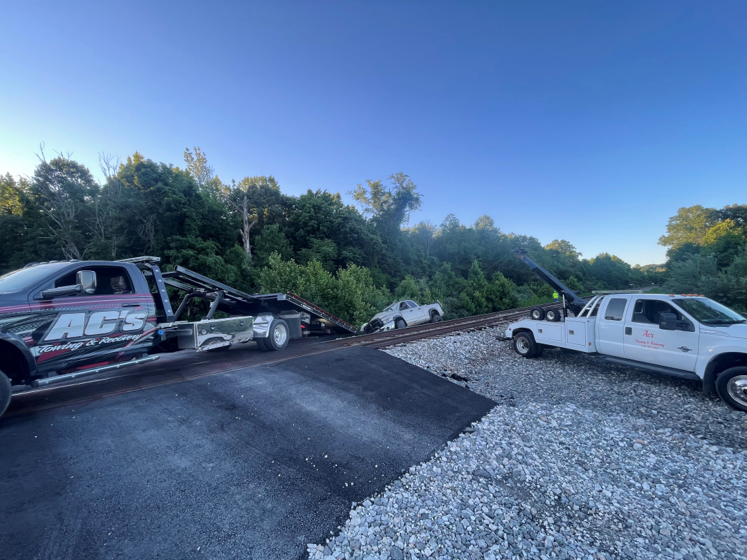 AC’s Towing recovering a vehicle beside the railroad tracks